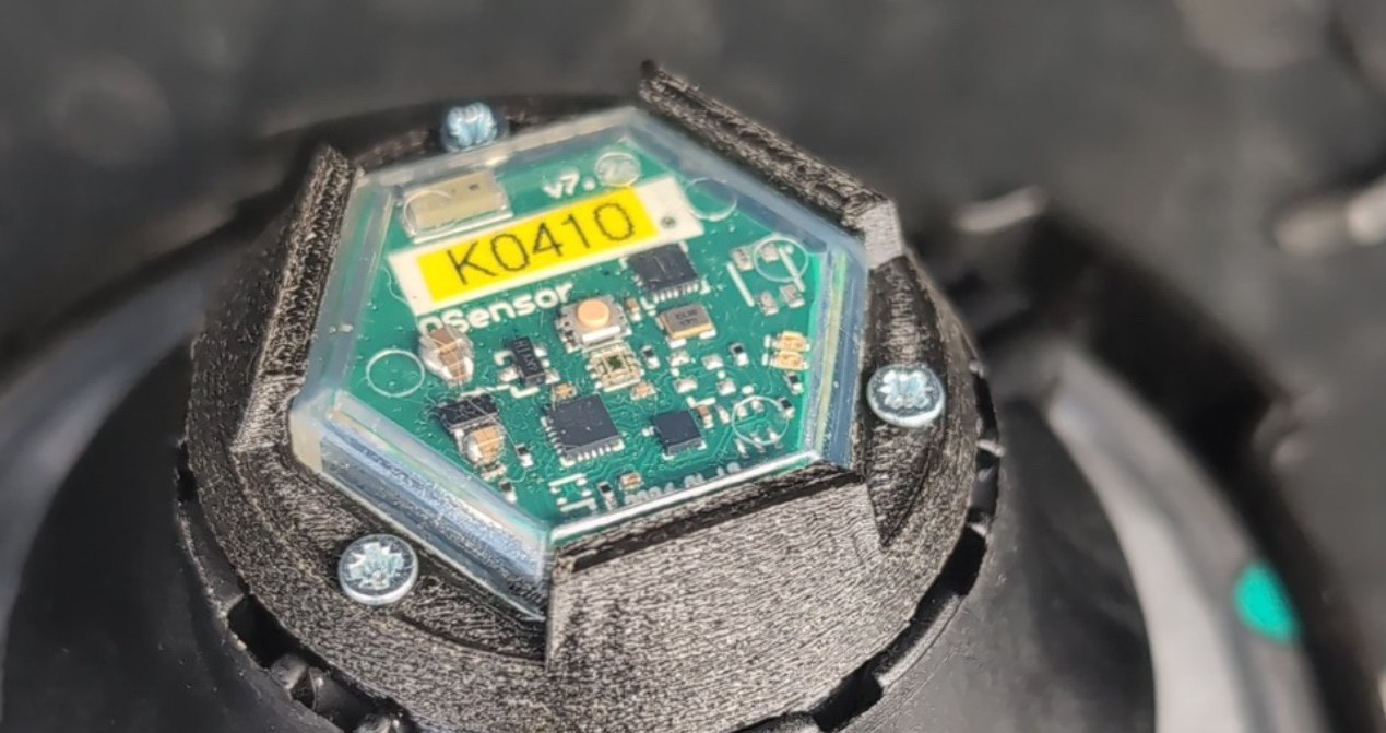 Czujnik QSensor FuelCap o numerze K0410 zamontowany w adapterze na korku paliwa, korek wlewu paliwa z czujnikiem otwarcia